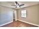 Bright bedroom features a ceiling fan, wood floors, window and closet at 7504 Willow Wisp E Dr, Lakeland, FL 33810