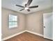 A bright bedroom featuring a ceiling fan and hardwood floors at 7504 Willow Wisp E Dr, Lakeland, FL 33810