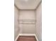 A large walk-in closet offers plenty of space for storage with a rod and shelf and hardwood floors at 7504 Willow Wisp E Dr, Lakeland, FL 33810
