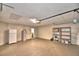 Spacious two-car garage with a concrete floor, water heater, shelving, and room for storage at 7504 Willow Wisp E Dr, Lakeland, FL 33810