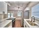 Modern kitchen with white cabinets, stainless steel appliances and stone countertops at 7504 Willow Wisp E Dr, Lakeland, FL 33810