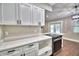 Bright kitchen featuring stainless steel appliances and white cabinetry at 7504 Willow Wisp E Dr, Lakeland, FL 33810