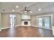 Large living room with hardwood floors, fireplace and double doors to the backyard patio at 7504 Willow Wisp E Dr, Lakeland, FL 33810
