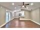 Spacious living room with hardwood floors, ceiling fan and modern lighting at 7504 Willow Wisp E Dr, Lakeland, FL 33810
