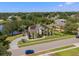 Stunning aerial view of home with solar panels, landscaped yard, and tranquil lake nearby at 8131 Vineland Oaks Blvd, Orlando, FL 32835