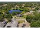 Beautiful aerial view of a lakeside home with mature trees and a lush green lawn at 8131 Vineland Oaks Blvd, Orlando, FL 32835