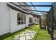 Screened-in lanai featuring modern design, backyard landscaping, and outdoor sitting space at 8131 Vineland Oaks Blvd, Orlando, FL 32835
