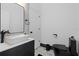 Modern bathroom features a stylish vessel sink, sleek black fixtures, and monochrome accents at 8131 Vineland Oaks Blvd, Orlando, FL 32835