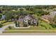 Stately two-story home featuring solar panels, lush landscaping, and a well-manicured lawn at 8131 Vineland Oaks Blvd, Orlando, FL 32835