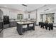 Modern kitchen with gray cabinets, stone countertops, and a large center island at 8131 Vineland Oaks Blvd, Orlando, FL 32835