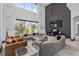 Elegant living room showcasing high ceilings, expansive windows, and stylish modern furniture at 8131 Vineland Oaks Blvd, Orlando, FL 32835