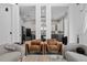 Open-concept living area with modern chairs and view of the kitchen in a modern home at 8131 Vineland Oaks Blvd, Orlando, FL 32835