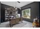 Home office with dark walls, modern desk, built-in bookshelves, and large window at 8131 Vineland Oaks Blvd, Orlando, FL 32835