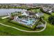 Aerial view of the community clubhouse, pool, playground, and surrounding lake at 8818 Bismarck Palm Dr, Winter Garden, FL 34787