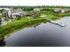 Stunning aerial view of waterfront property with a fishing pier and lush green landscape at 8818 Bismarck Palm Dr, Winter Garden, FL 34787