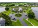Overhead view of community clubhouse with a manicured island, lake and surrounding neighborhood at 8818 Bismarck Palm Dr, Winter Garden, FL 34787