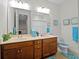 Bathroom featuring a double vanity and commode at 8818 Bismarck Palm Dr, Winter Garden, FL 34787