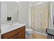 Bathroom featuring a single vanity and a bathtub with colorful shower curtain at 8818 Bismarck Palm Dr, Winter Garden, FL 34787