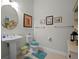 Cozy half bathroom featuring a pedestal sink, toilet, and framed pictures at 8818 Bismarck Palm Dr, Winter Garden, FL 34787