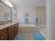 This primary bathroom features double sinks, a soaking tub, and a glass enclosed shower at 8818 Bismarck Palm Dr, Winter Garden, FL 34787