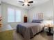 Comfortable bedroom featuring a ceiling fan, window, and closet at 8818 Bismarck Palm Dr, Winter Garden, FL 34787