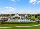 Beautiful community pool area with lounging chairs and pergola with view of the lake at 8818 Bismarck Palm Dr, Winter Garden, FL 34787