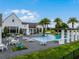 Inviting community pool area with palm trees and plenty of lounge chairs with a lakeside view at 8818 Bismarck Palm Dr, Winter Garden, FL 34787
