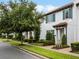 Charming townhouse with manicured landscaping, terracotta roof, and white facade at 8818 Bismarck Palm Dr, Winter Garden, FL 34787