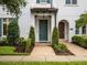 Attractive townhome with landscaped entryway, featuring brick paths and lush bushes at 8818 Bismarck Palm Dr, Winter Garden, FL 34787