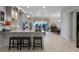 Spacious open kitchen featuring gray cabinetry, granite counters, stainless appliances, and a large island with bar seating at 8818 Bismarck Palm Dr, Winter Garden, FL 34787