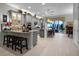 Open concept kitchen features an island with seating and modern appliances at 8818 Bismarck Palm Dr, Winter Garden, FL 34787