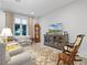 Comfortable living area with vintage furniture and a bright window view at 8818 Bismarck Palm Dr, Winter Garden, FL 34787