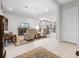 Spacious living room with tile floors and an open view to the kitchen at 8818 Bismarck Palm Dr, Winter Garden, FL 34787