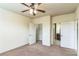 Bedroom featuring a ceiling fan, closet, and entry to the bathroom at 909 Charo Pkwy # 1011, Davenport, FL 33897