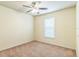 Bedroom with neutral carpet, ceiling fan, and window at 909 Charo Pkwy # 1011, Davenport, FL 33897
