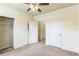 Bedroom with carpet, ceiling fan, and access to closet and other rooms at 909 Charo Pkwy # 1011, Davenport, FL 33897