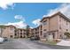 Apartment complex featuring stone accents, balconies, ample parking and nice landscaping at 909 Charo Pkwy # 1011, Davenport, FL 33897