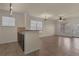 Open kitchen with stainless steel sink and appliances, granite countertops, and tile floors leading to the living area at 909 Charo Pkwy # 1011, Davenport, FL 33897