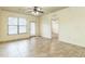 Sunny living room featuring tile floors, a ceiling fan, and access to a balcony at 909 Charo Pkwy # 1011, Davenport, FL 33897