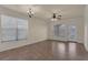 Spacious living room with tile flooring, multiple windows, and ample natural light at 909 Charo Pkwy # 1011, Davenport, FL 33897