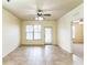 Bright living room with tile flooring, a ceiling fan, and a glass door leading to the outside at 909 Charo Pkwy # 1011, Davenport, FL 33897