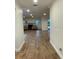 Bright, open hallway showcasing newly installed ceramic tile flooring leading to the living area at 955 Gamewell Ave, Maitland, FL 32751