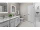 Bathroom featuring dual sinks, quartz counters, modern lighting, and decorative tile at 9670 Cypress Pine St, Orlando, FL 32827