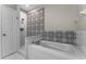Bathroom with a jacuzzi bathtub, shower and black and white decorative tile at 9670 Cypress Pine St, Orlando, FL 32827