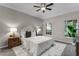 Bedroom with neutral walls, ceiling fan, and bright windows overlooking greenery at 9670 Cypress Pine St, Orlando, FL 32827