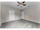 Neutral-toned bedroom featuring a ceiling fan, carpeted floor and two closets at 9670 Cypress Pine St, Orlando, FL 32827