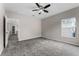 Bright carpeted bedroom featuring a ceiling fan, a window and a view to other rooms at 9670 Cypress Pine St, Orlando, FL 32827
