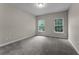 Bedroom with neutral walls, carpet, and two bright windows for natural light at 9670 Cypress Pine St, Orlando, FL 32827