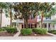 Charming brick townhome with a cozy front porch and lush landscaping provides inviting curb appeal at 9670 Cypress Pine St, Orlando, FL 32827