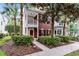 Two story brick townhome featuring a second story porch, landscaped yard, and beautiful curb appeal at 9670 Cypress Pine St, Orlando, FL 32827